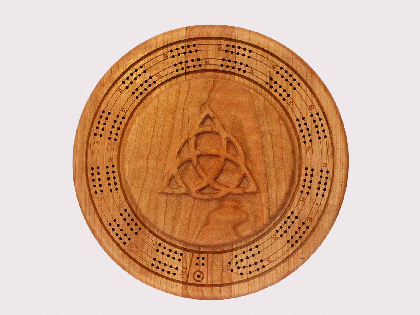 Overhead view of round cherry wood cribbage board featuring Celtic Trinity Knot design on lid of storage compartment