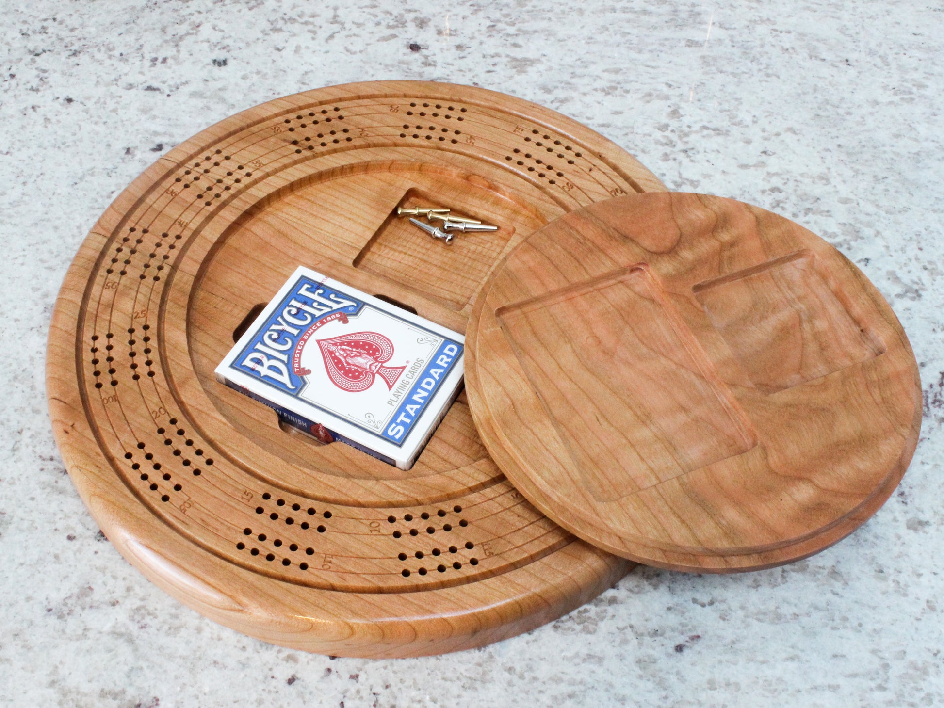 Round cherry wood cribbage board including a fresh deck of cards and token pins