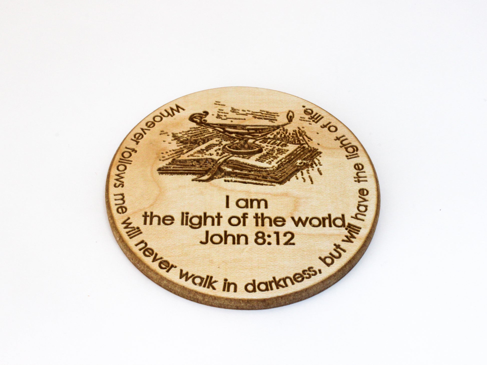 Wood coaster featuring an image of a lamp and an open Bible, as well as the text of John 8:12: "I am the light of the world. Whoever follows me will never walk in darkness, but will have the light of life." 