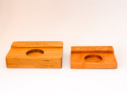 Large and small prayer card holders side by side for size comparison. Made of wood and featuring the words "Pray for Us" engraved in the wood.
